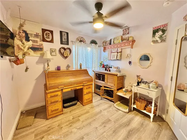 SECOND BEDROOM WITH LAMINATE FLOORS AND FANS