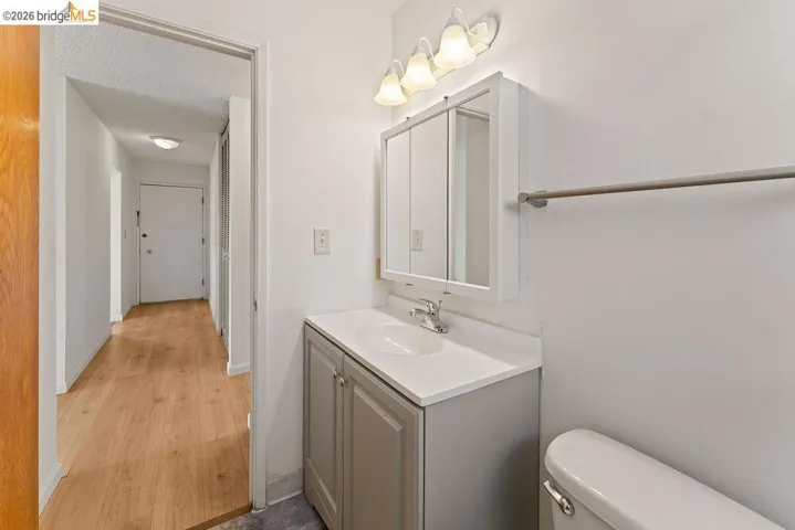Bathroom featuring vanity, a textured ceiling, and light wood-style floors