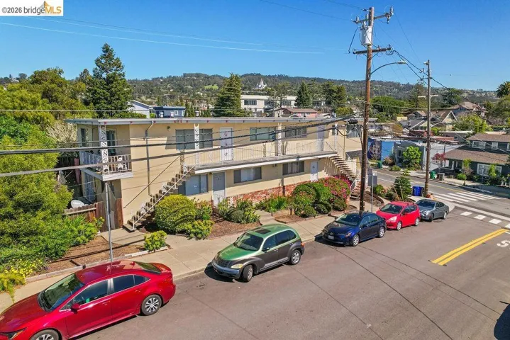 View of building exterior featuring stairs and a residential view