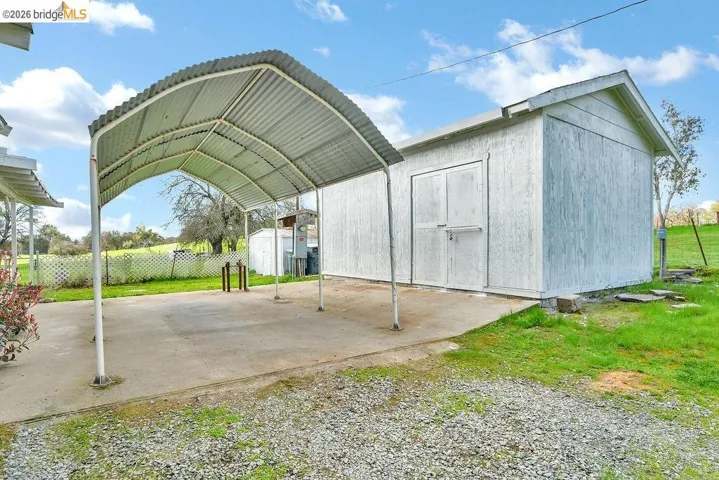 View of shed with a detached carport