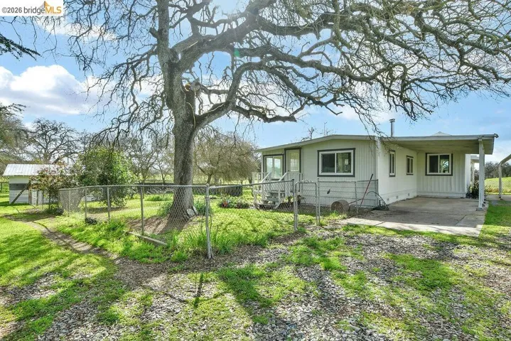 View of property exterior featuring a carport