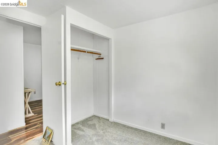 View of closet, half bath in bedroom.