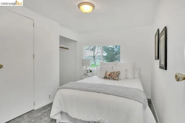 Bedroom featuring carpet flooring and a closet