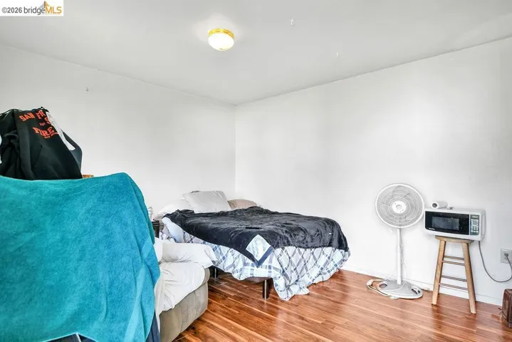 Bedroom with wood finished floors and baseboards