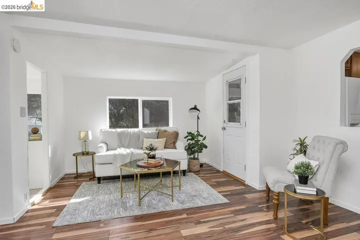 Living room with wood finished floors and arched walkways