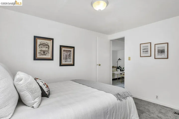 Bedroom featuring carpet floors and baseboards