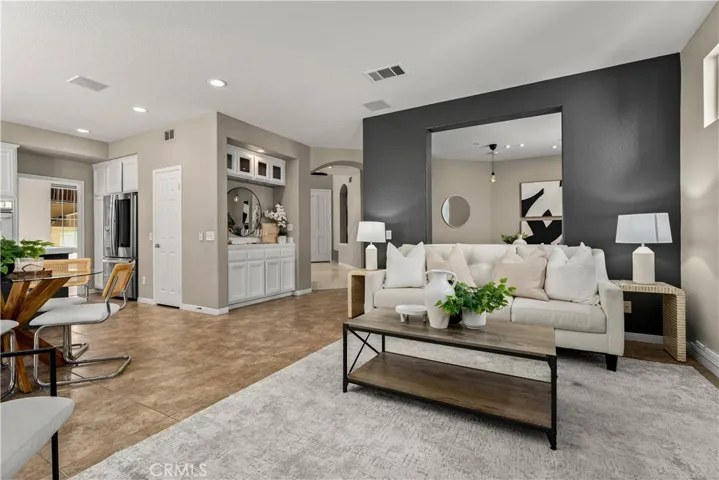 Family room looking towards wet bar and front doors beyond