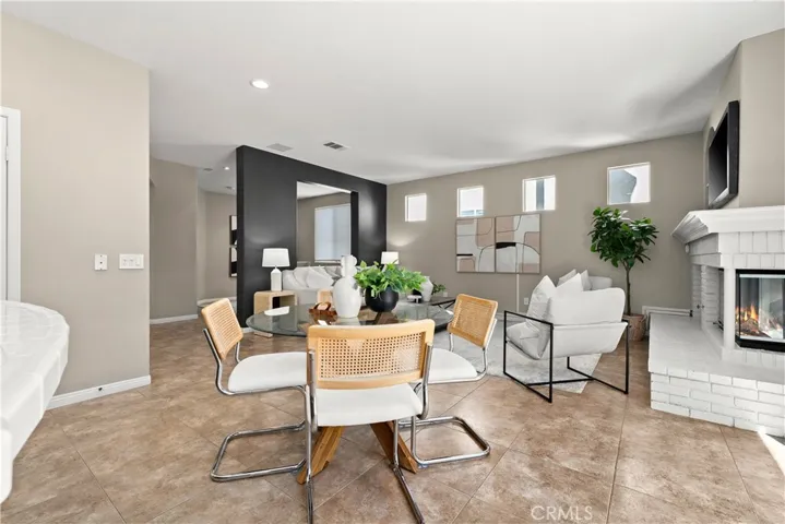 Breakfast nook located between kitchen and family room. Fire has been digitally added to the fieplace