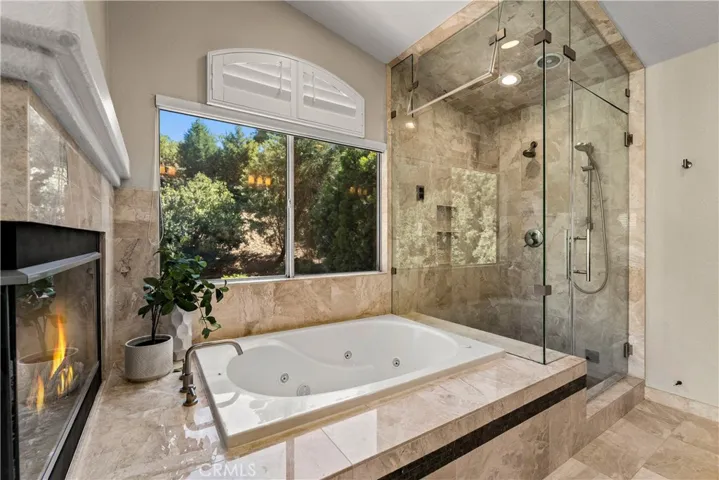 Primary bath. Fire has been digitally added to fireplace