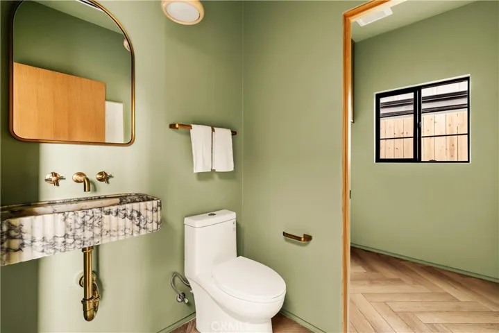 Powder room w/ imported italian marble sink and adjacent laundry room