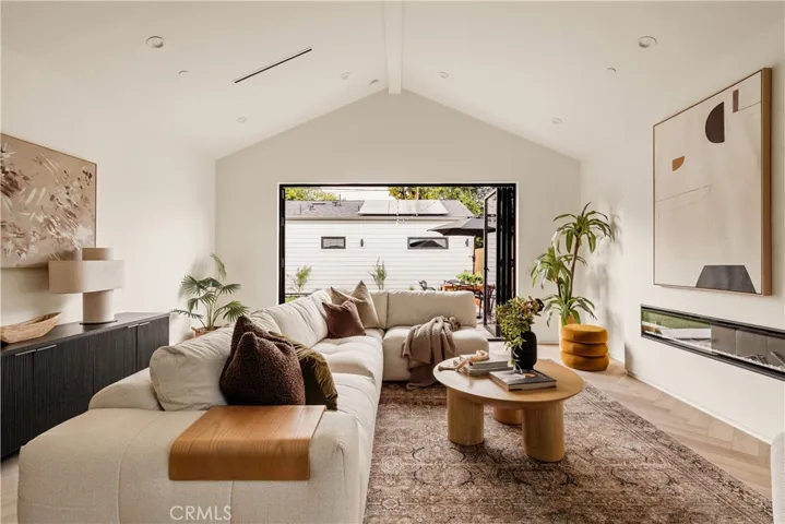 Aluminum bi-fold doors open out to a backyard oasis