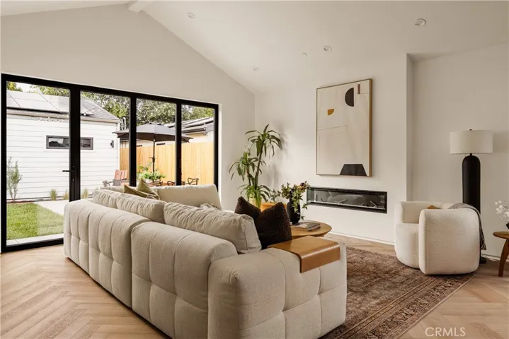 Cozy color-changing electric fireplace pre-wired with electrical outlets above it for TV and entertainment systems