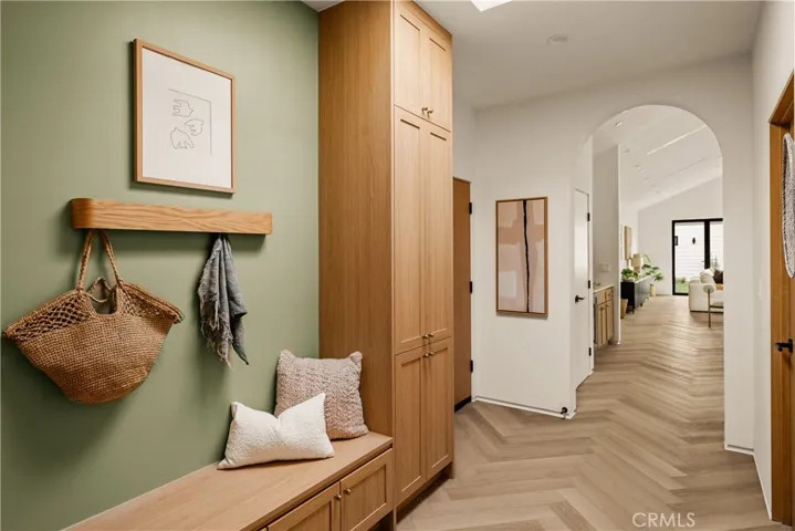 Formal entry w/ built-in storage and seating, bathed in natural light