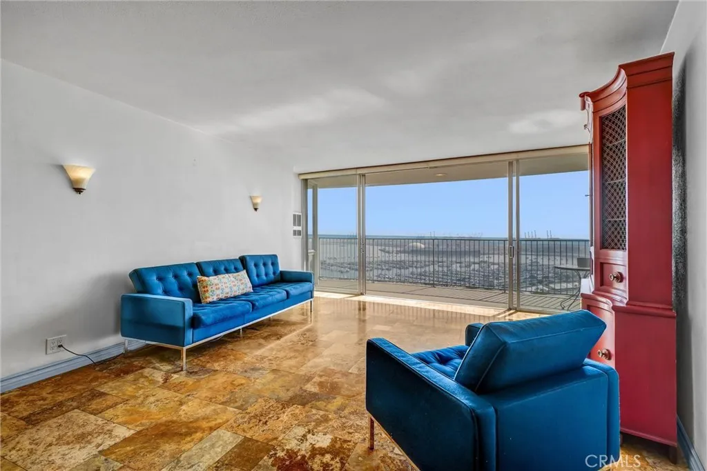 Southeast-facing living room offering stunning views of Queen Mary and Marina.