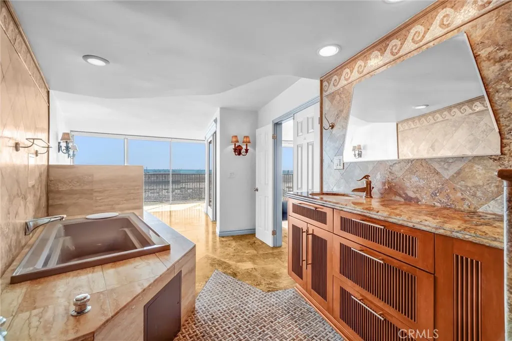 Elegant vanity area featuring bespoke cabinetry and stunning panoramic ocean views.