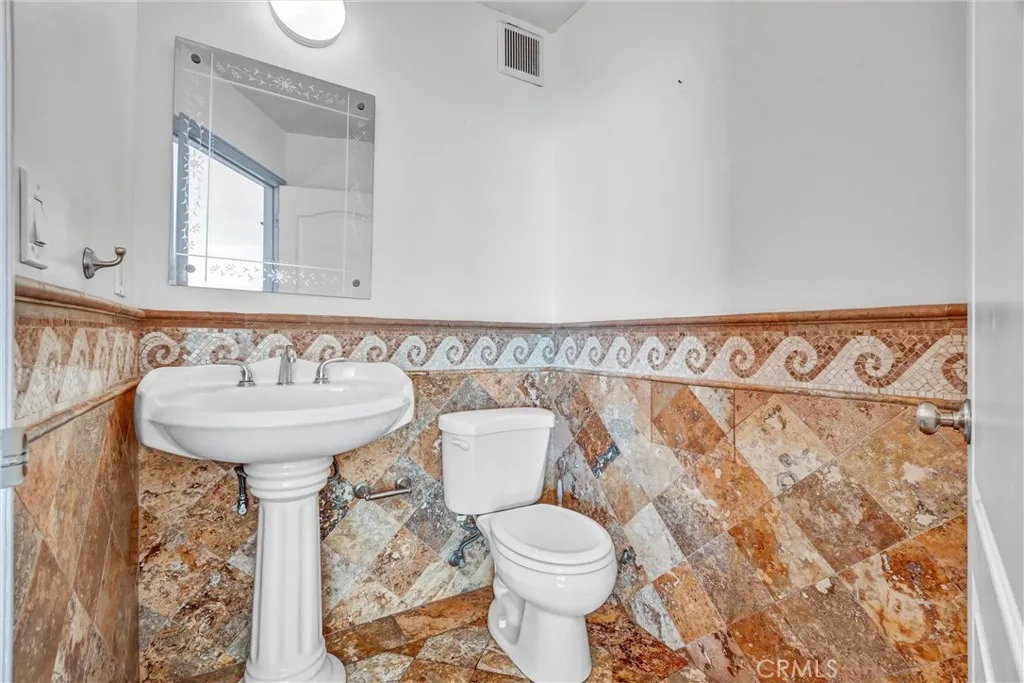 Guest half bathroom situated just off the living room for easy access.

Option 3 (luxury tone):