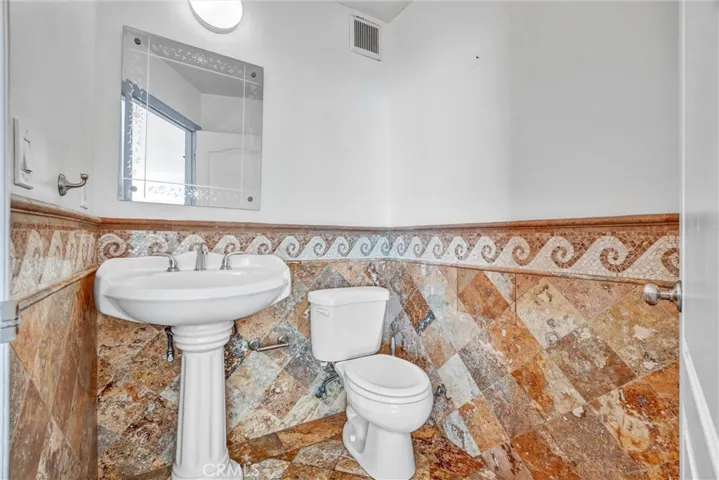 Guest half bathroom situated just off the living room for easy access.

Option 3 (luxury tone):
