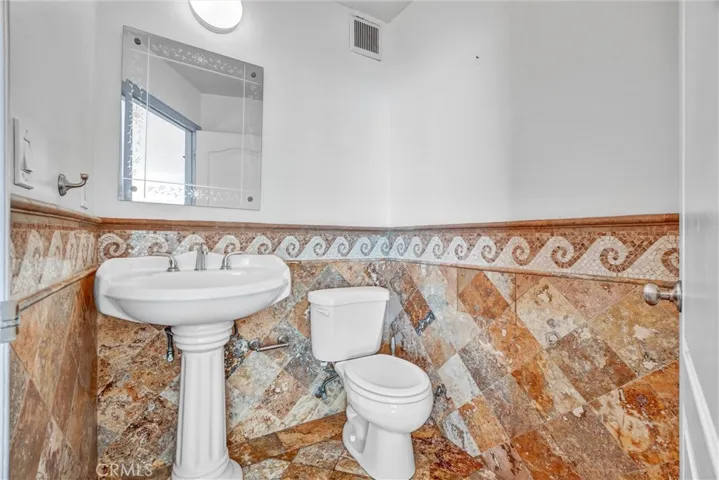 Guest half bathroom situated just off the living room for easy access.

Option 3 (luxury tone):