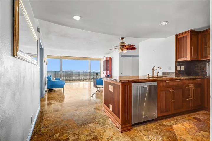 Upon entering, you are welcomed by ocean views, along with the kitchen and living room.