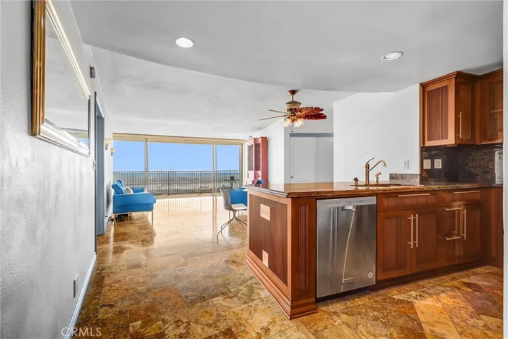 Upon entering, you are welcomed by ocean views, along with the kitchen and living room.