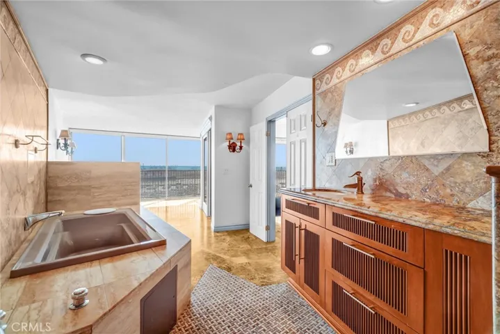 Sophisticated vanity area with bespoke cabinetry, offering breathtaking ocean views.