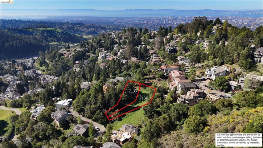 Aerial perspective of suburban area with property parcel outlined and a mountainous background