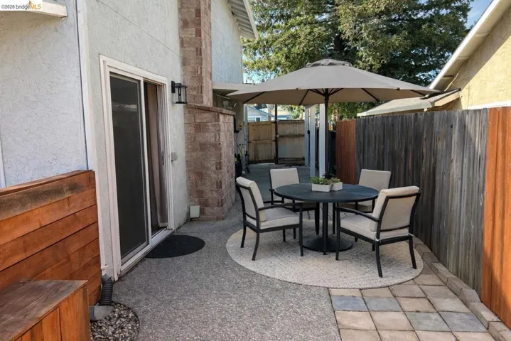 Fenced backyard with a patio area and outdoor dining space