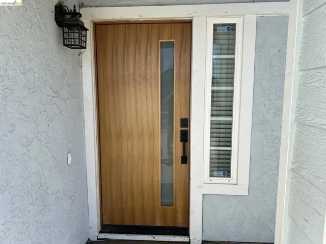 View of exterior entry featuring stucco siding