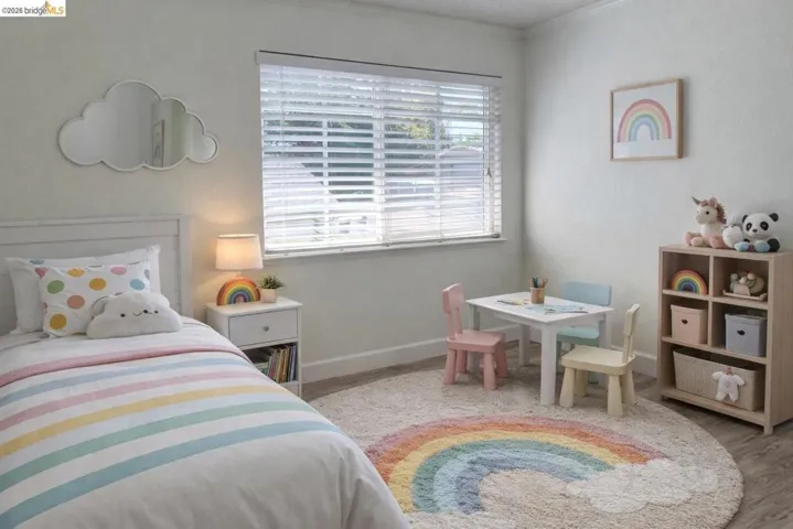 Bedroom featuring light wood-style floors and crown molding