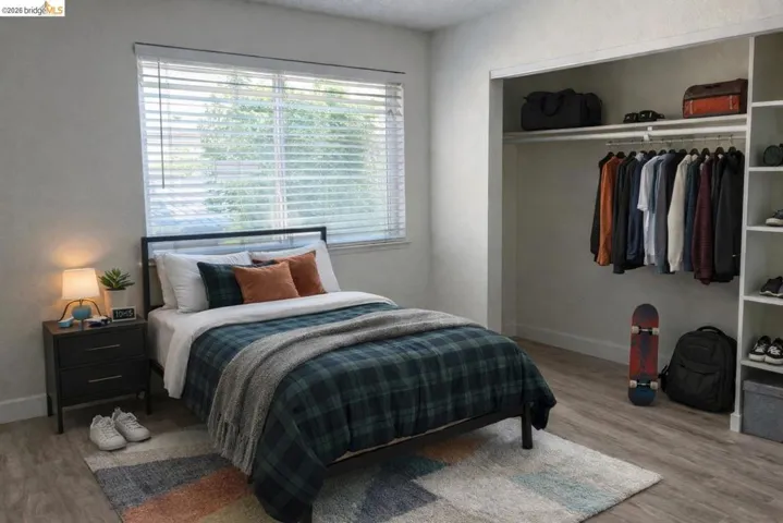Bedroom with a closet and light wood finished floors