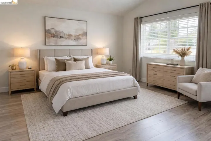 Bedroom featuring vaulted ceiling and light wood-type flooring