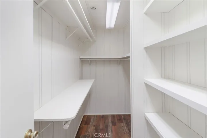 Primary Bedroom Walk in Closet With New Paint and Flooring