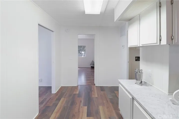 Hallway Looking into Primary With New Paint and Flooring