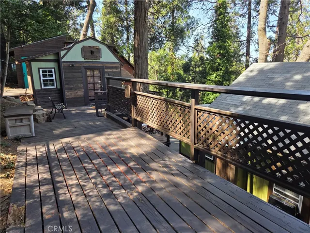 Deck behind main house and view of the additional two structures.