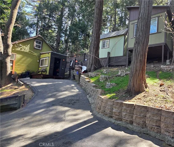 Main house entrance and outside view of the two additional structures.