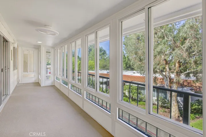 Enclosed covered balcony extends the length of the residence and is ideal for year-round entertaining, dining and relaxing.