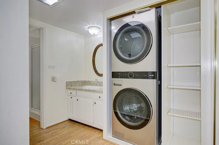 Full-size stackable washer-dryer combo is conveniently located in a closet in the primary baedrrom suite.