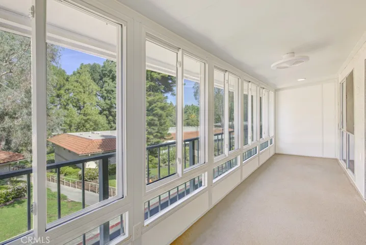 Another view of the enclosed covered balcony. Enjoy a lovely panoramic view of the neighborhood and endless trees.