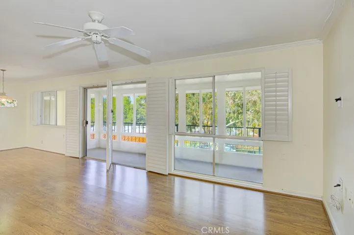 Another view of the living room. Glass slider opens to the enclosed covered balcony.
