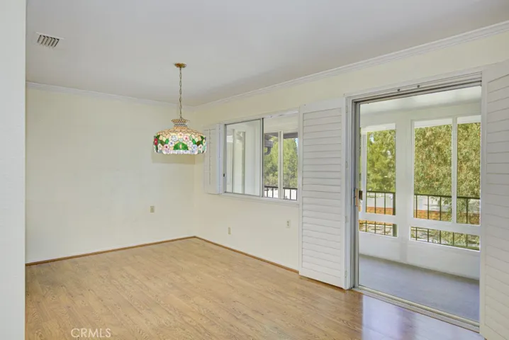 Dining area and entry to enclosed covered balcony.