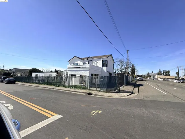 View of asphalt road featuring sidewalks and curbs