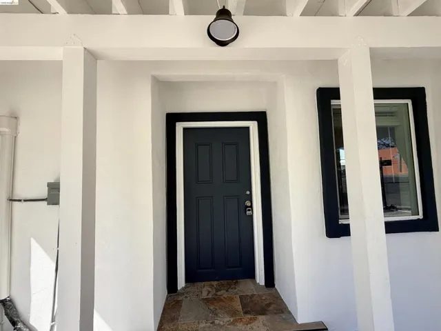 View of exterior entry with stucco siding