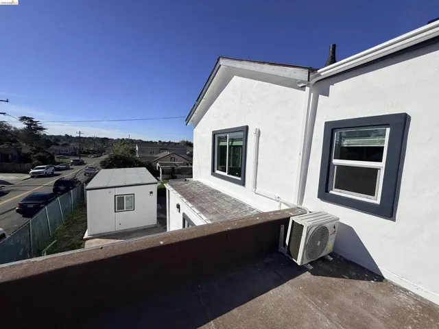 View of home's exterior with stucco siding and a balcony