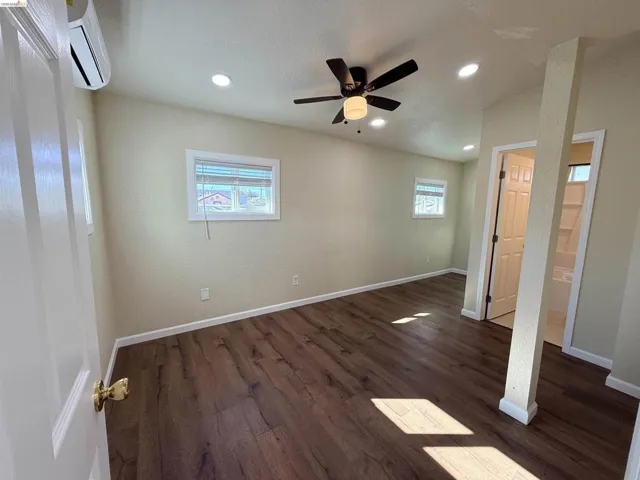 Unfurnished bedroom with dark wood-style flooring, a ceiling fan, and recessed lighting