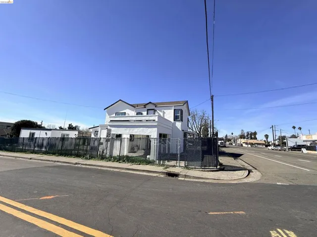 View of front facade featuring a fenced front yard and stucco siding
