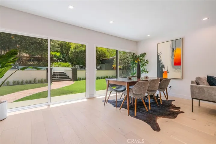 Dining area with glass doors creating seamless indoor-outdoor flow.