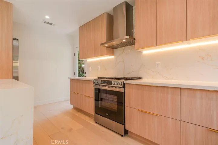 Dining area with floor-to-ceiling glass doors creating seamless indoor-outdoor flow.