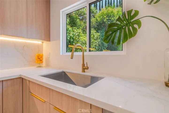 Designer farmhouse sink with quartz counters.
