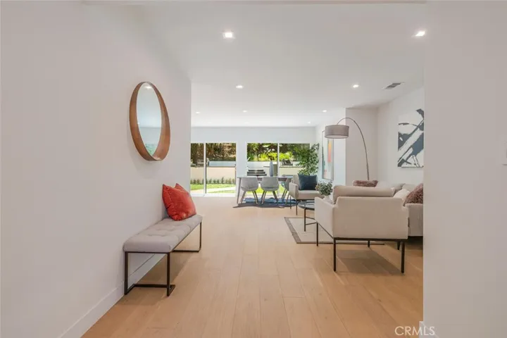 Wide view of the living area highlighting natural light and modern design.