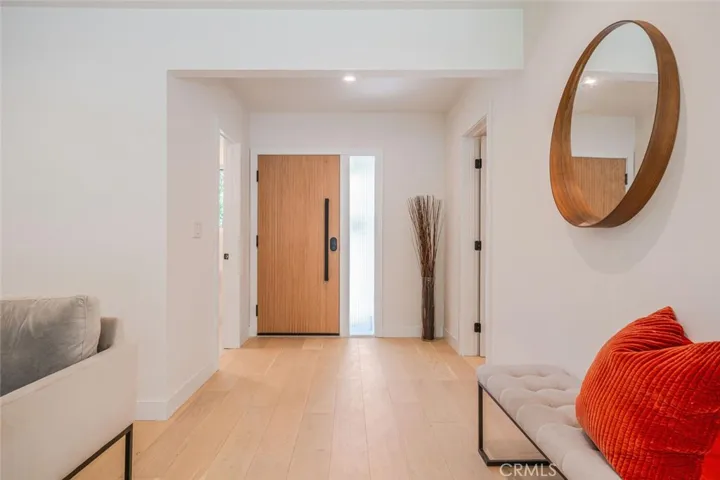 Clean modern hallway leading to bedrooms and hallway bath.